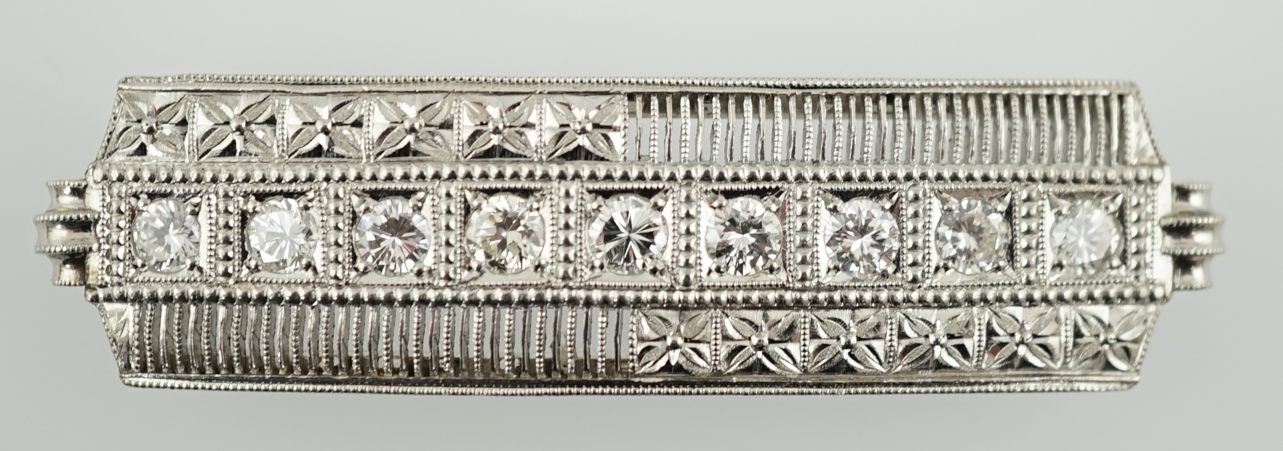 A platinum and eight stone diamond set concave clasp/attachment